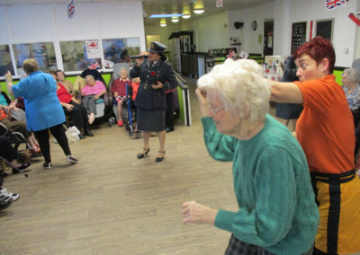 Residents dancing to The Good Time Sweethearts singing in the lounge area