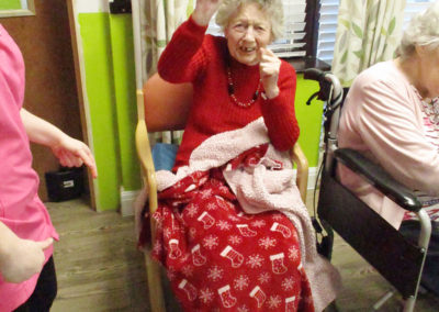 St Winifreds resident dancing in her chair to The Good Time Sweethearts
