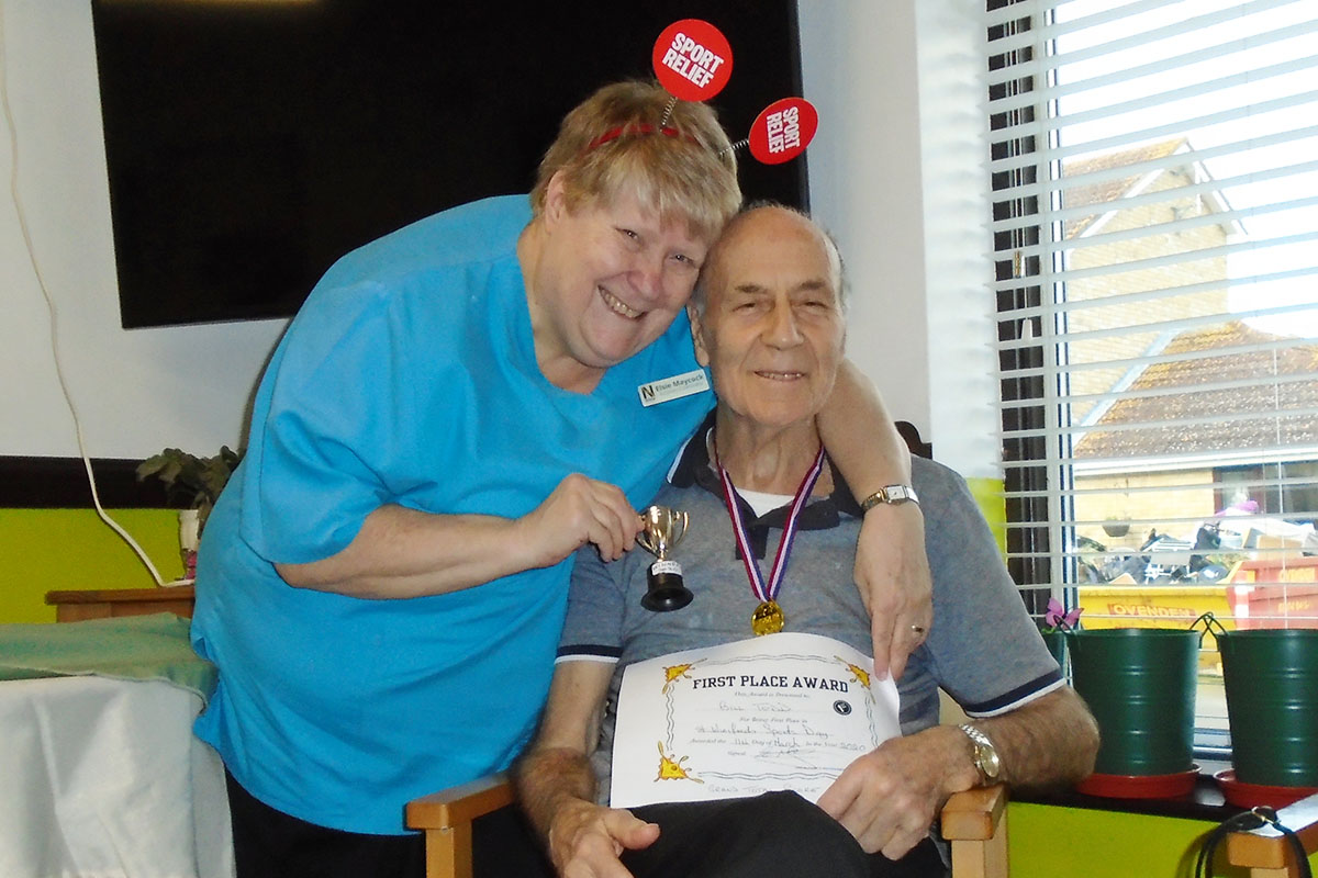 Staff member and winning resident receiving his Sports Relief certificate at St Winifreds Care Home