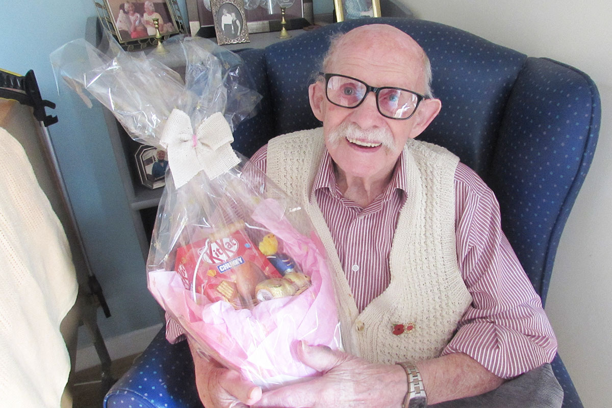 Gentleman resident at St Winifreds receiving a gift Easter egg