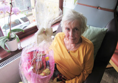 Lady resident at St Winifreds receiving a gift Easter egg