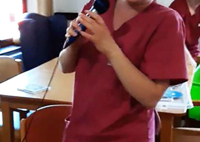 Carer Jess singing to residents at St Winifreds Residential Care Home