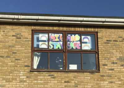 Rainbow and smile posters in the windows at St Winifreds Residential Care Home