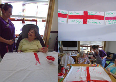 St Winifreds Care Home resident painting a St George's Day flag