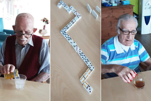 St Winifreds Care Home gents enjoying a drink and a game of dominoes