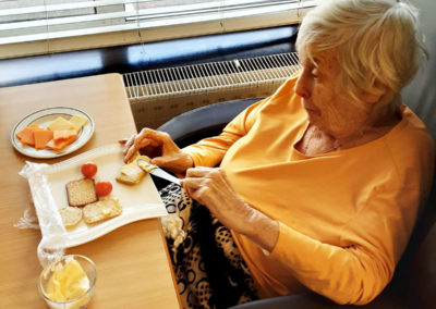 St Winifreds Residential Care Home lady resident preparing sandwiches