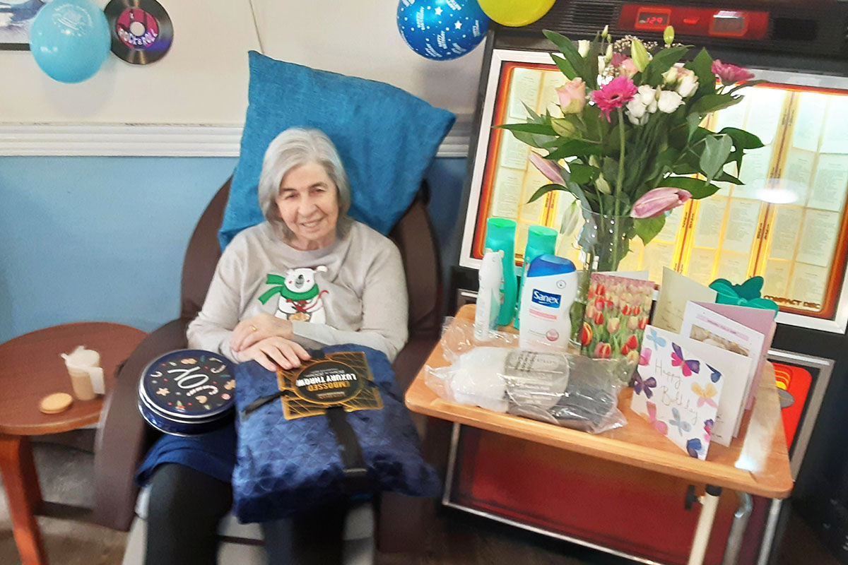Resident with her birthday cards and gifts at St Winifreds Care Home