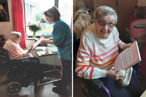 St Winifreds Care Home resident receiving a photo album from her 100th birthday from a staff member