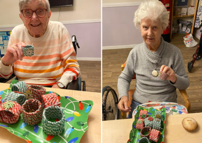 St Winifreds Care Home residents showing off their homemade festive table decorations