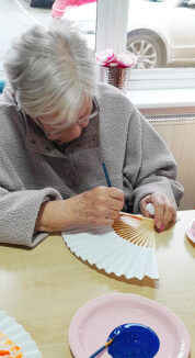 St Winifreds Care Home resident decorating a fan